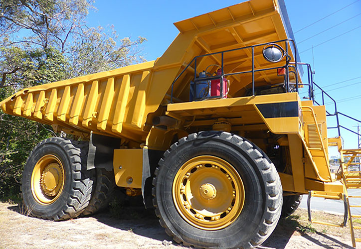 Plant operator training on dump truck in industrial yard